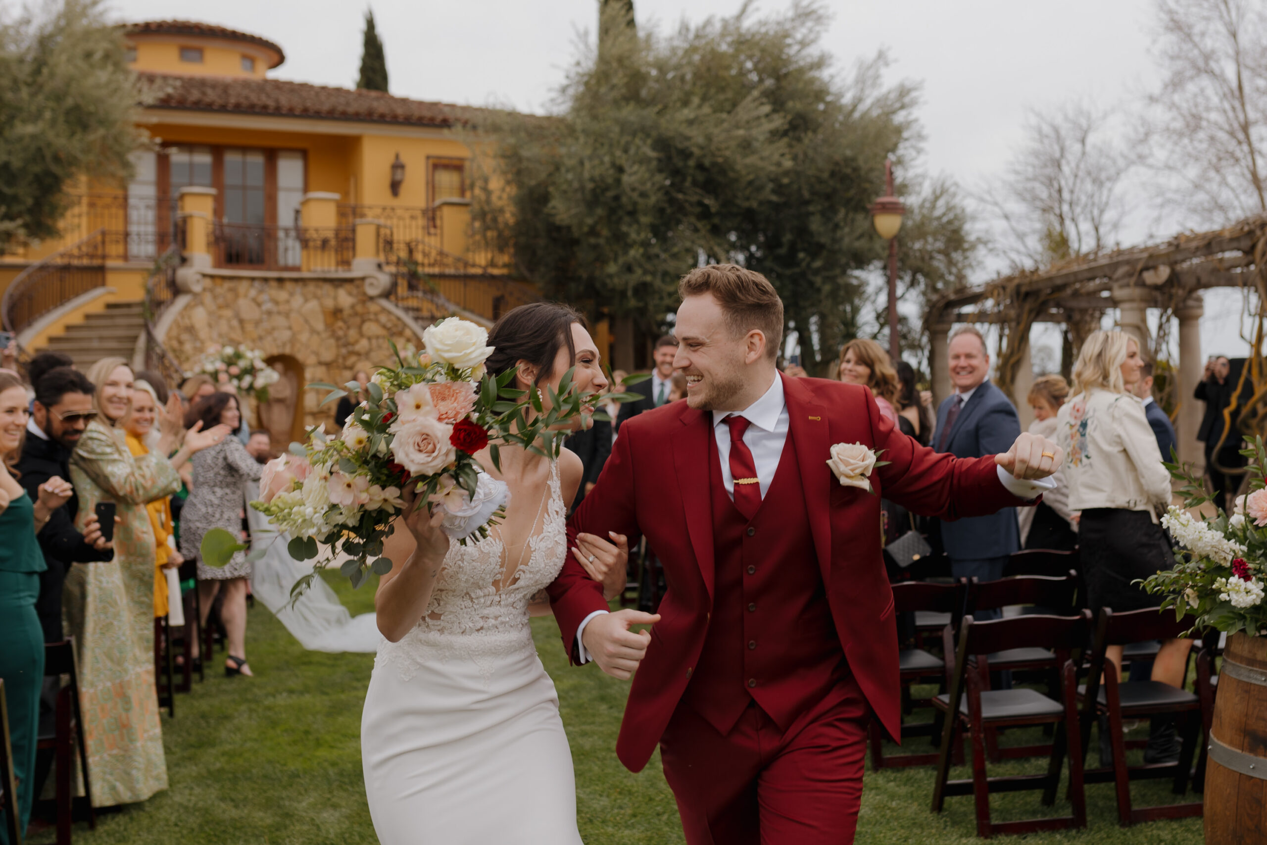 bride and groom celebrating during the recessional after their ceremony at CaliPaso Winery in Paso Robles