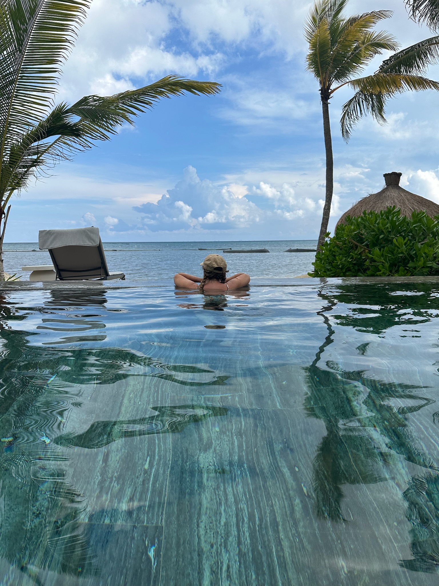 Newlywed bride in a pool at an all-inclusive resort in Mexico for her honeymoon